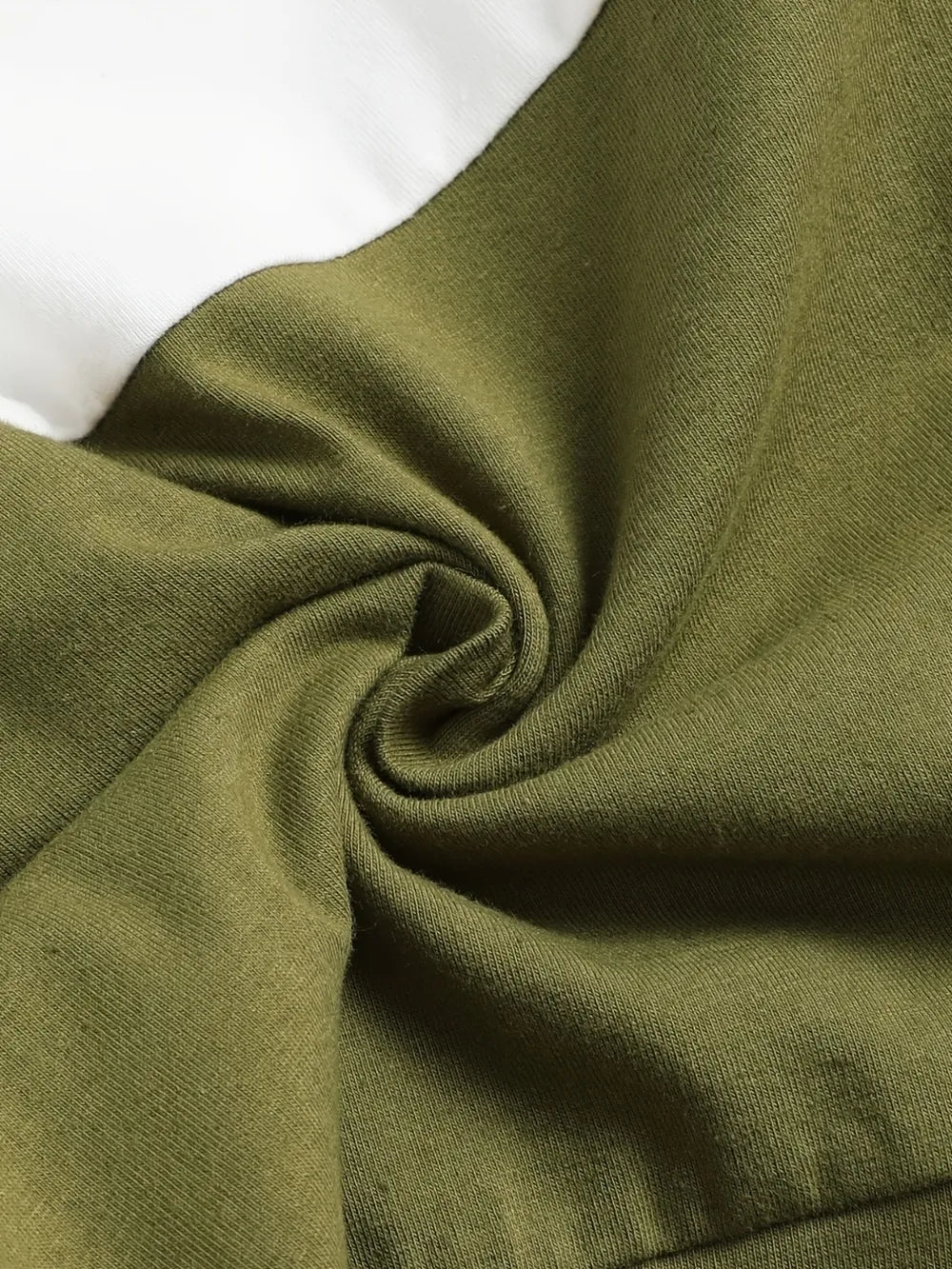 Curled fabric in olive green and white, showcasing a soft, textured surface.