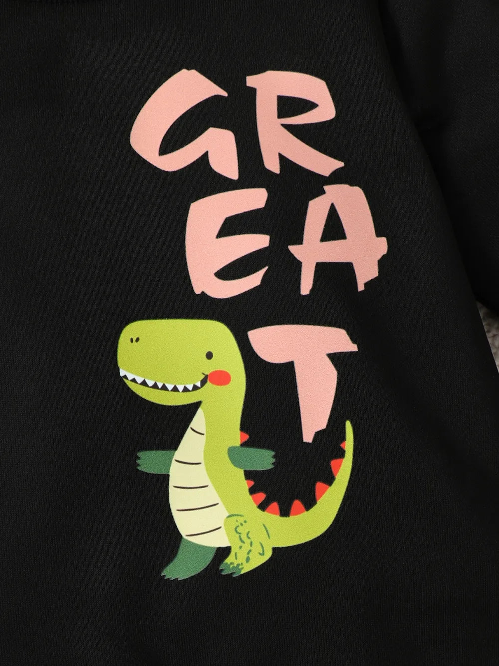 Green cartoon dinosaur with the word "GREAT" in playful pink letters on a black background.