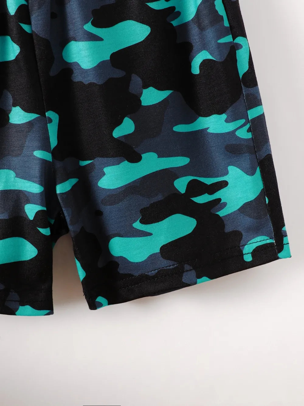 Camo-patterned shorts featuring shades of blue and black with a smooth fabric texture.