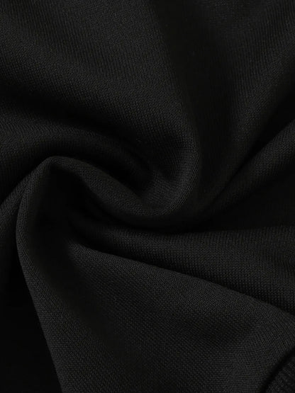 Black fabric with a smooth texture, slightly wrinkled and folded, showcasing deep color.