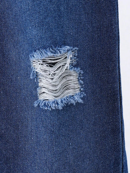 Frayed tear in denim fabric showcasing contrasting blue and white textures.