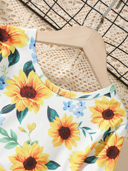 Floral-patterned fabric featuring vibrant sunflowers on a light background, draped over a hanger.